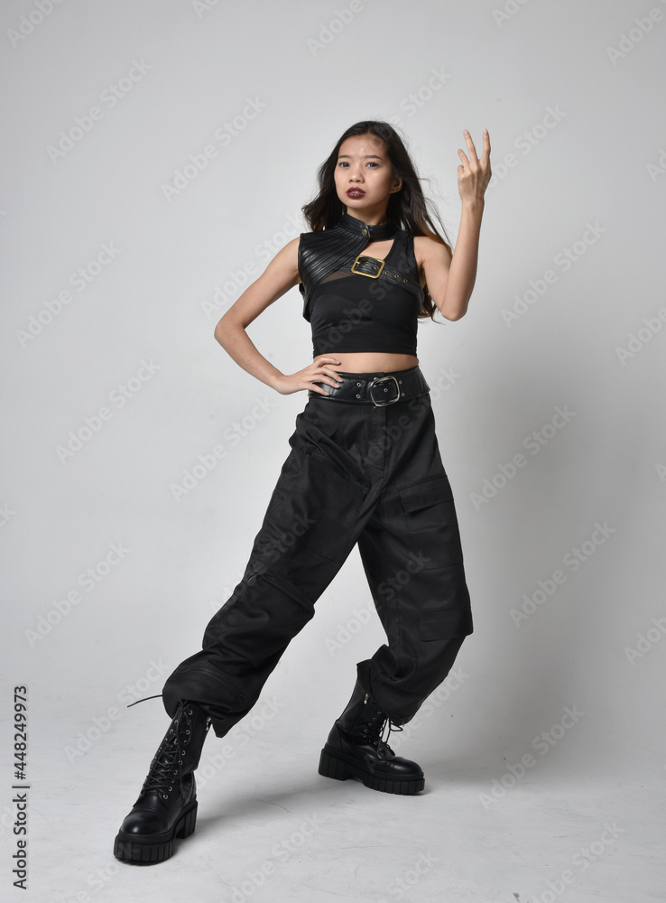 Full length portrait of pretty young asian girl wearing black tank top ...