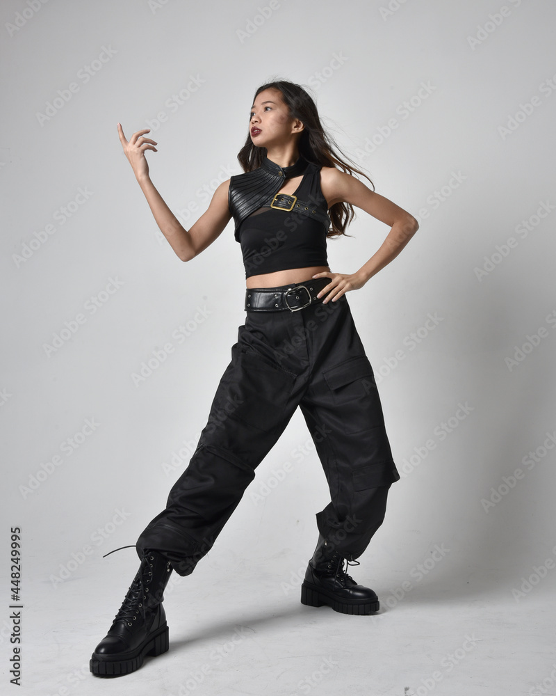 Full length portrait of pretty young asian girl wearing black tank top ...