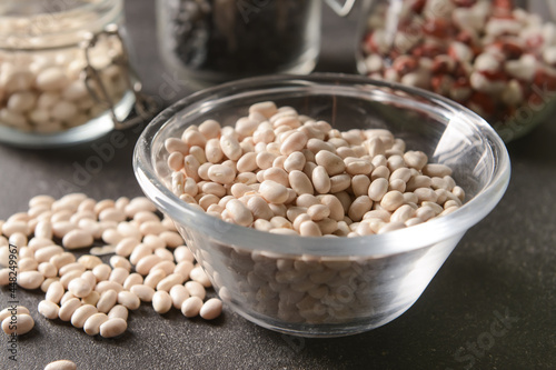 Bowl with raw beans on dark...