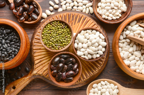 Composition with different legumes on wooden background