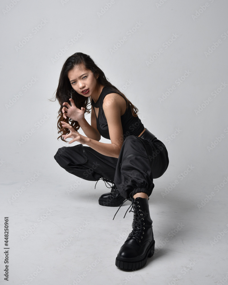 Full length portrait of pretty young asian girl wearing black tank top ...