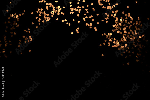 Festive black background with shining heart on black background. Wallpaper vor Christmas, Valentine's Day.  copy space.