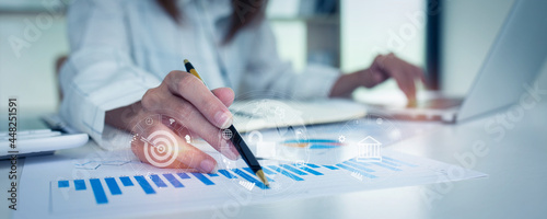 Financial Businesswomen analyze the graph of the company's performance to create profits and growth,Market research reports and income statistics,double exposure with Financial Accounting concept. photo