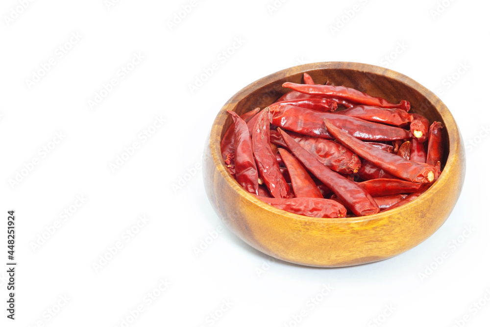 Obraz premium Dried pepper chillies in wooden bowl on white background.