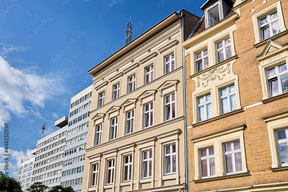 the facades of historic buildings and a modern office buildings