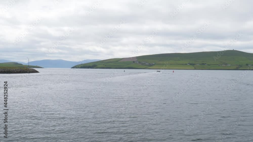 Tourists Riding On A Boat Sailing On Dingle Bay In County Kerry, Western Ireland. panning right Tourists Riding On A Boat Sailing On Dingle Bay In County Kerry, Western Ireland. panning right