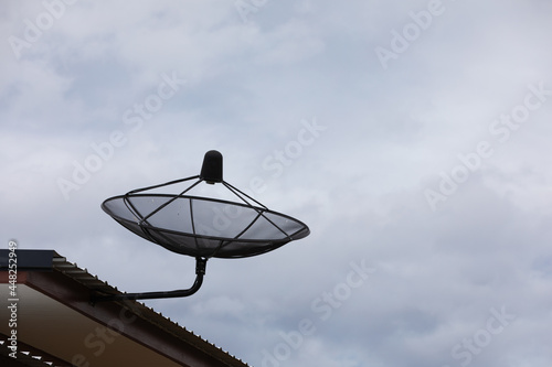 Satellite dishes are installed on the roofs of houses