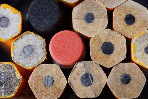 Close up of a Stack of unsharpened pencils and erasers writing instruments.