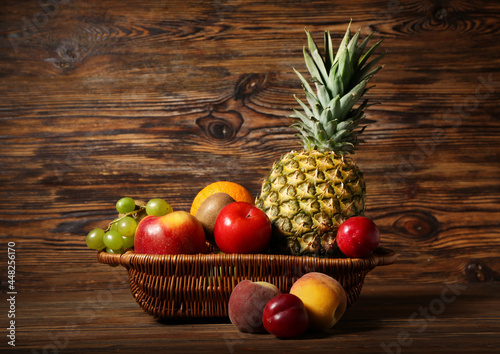 Fototapeta Naklejka Na Ścianę i Meble -  Basket with fresh fruits on wooden background