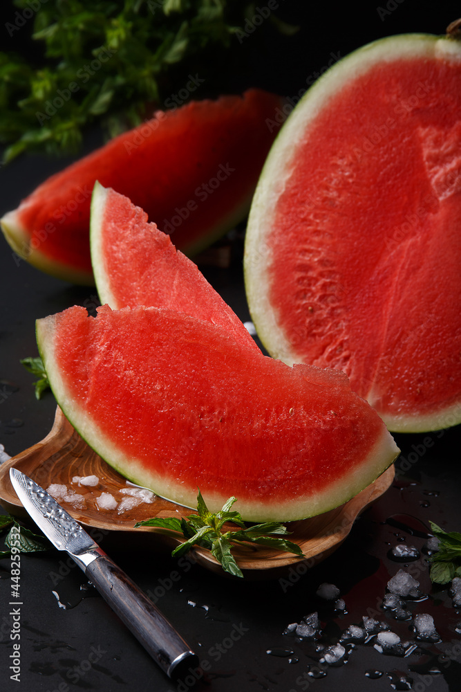 Fresh piece of watermelon on a black background, refreshing and healthy snack, tropical fruit