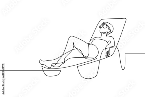 Woman relaxing on a beach lounge chair in continuous line art drawing style. Wellness and relax time. Happy summer vacation. Black linear sketch isolated on white background. Vector illustration