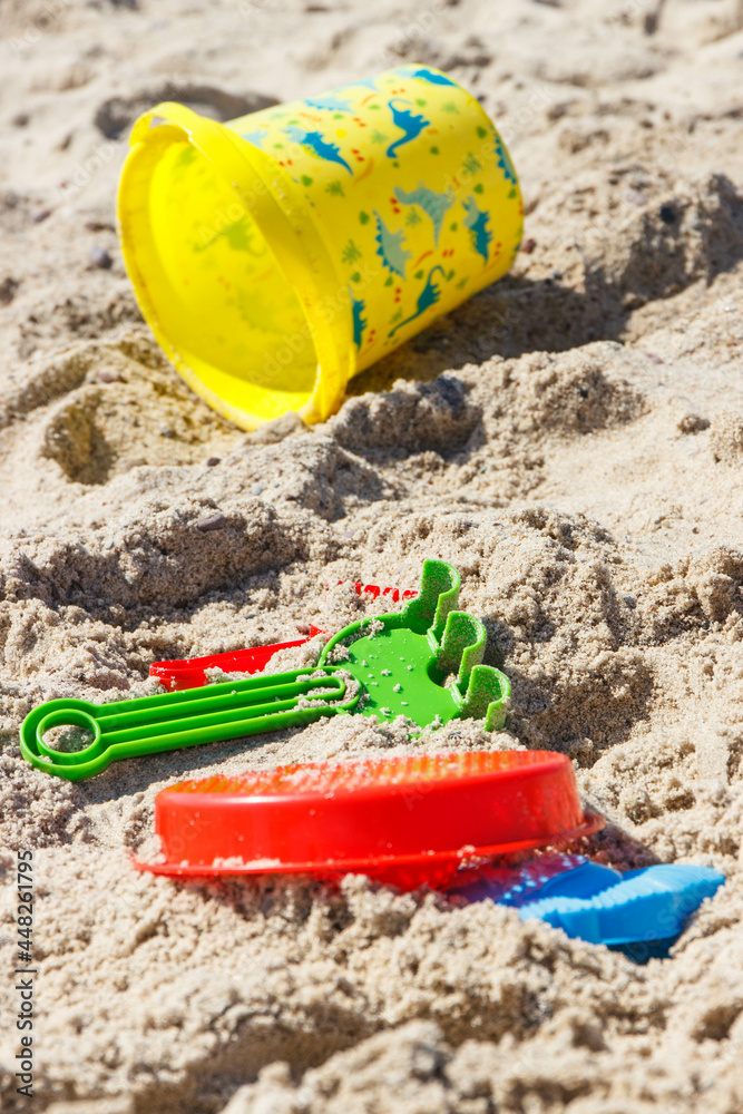 Different shapes made of sand and children toys for playing on beach. Summer, vacation time and child development Different shapes made of sand and children toys for playing on beach. Summer, vacation time and child development