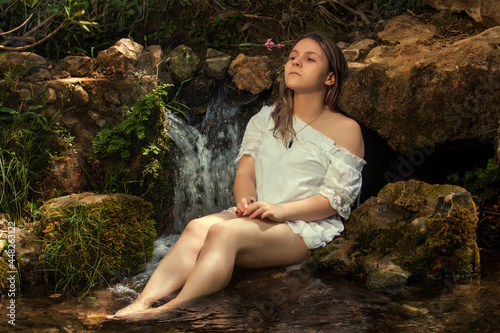 woman with white dress near stream of water