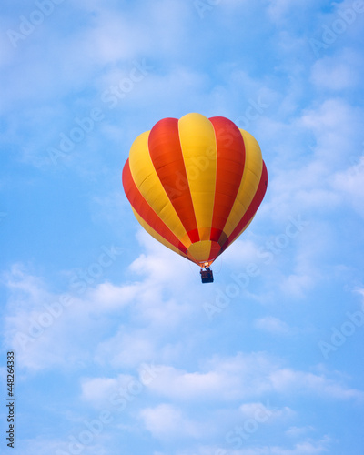 Red and yellow hot air balloon  in a blue sky