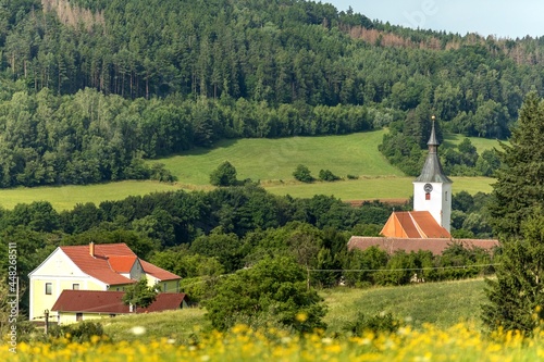 Old white church in the countryside. Panorama of green landscape with church. Gothic church of St. Martin. Village Dolni Loucky - Czech Republic.