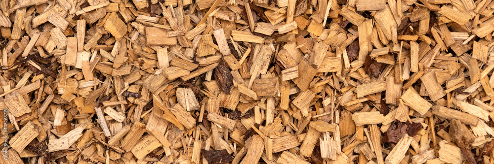 Panoramic background. Bark mulch, brown wood chips Panoramic background. Bark mulch, brown wood chips