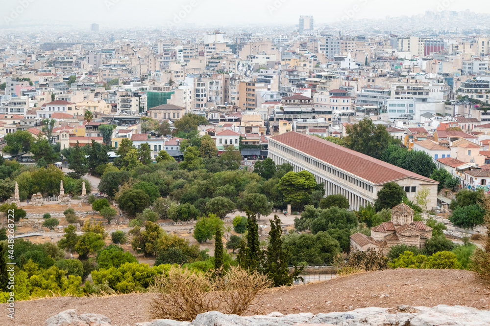 View on Stoa of Attalos, Odeon of Agrippa and Athens old city center with white buildings on gray foggy day from Areopagus - Hill near Acropolis