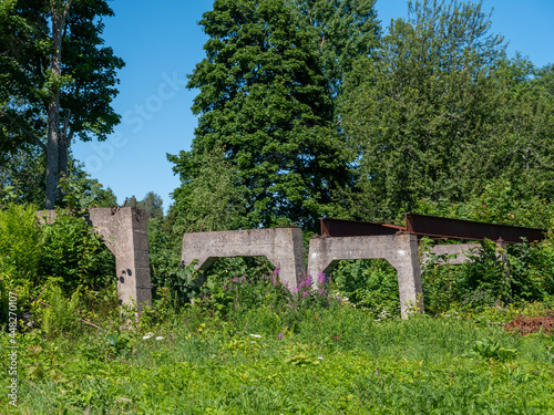 Concrete foundations and with part of railroad tracks mounted. Vegetation and trees surrounds the structure. Shot in Sweden, Scandinavia