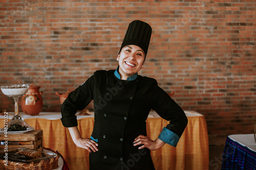 Portrait of latin female chef smiling in mexican restaurant photo