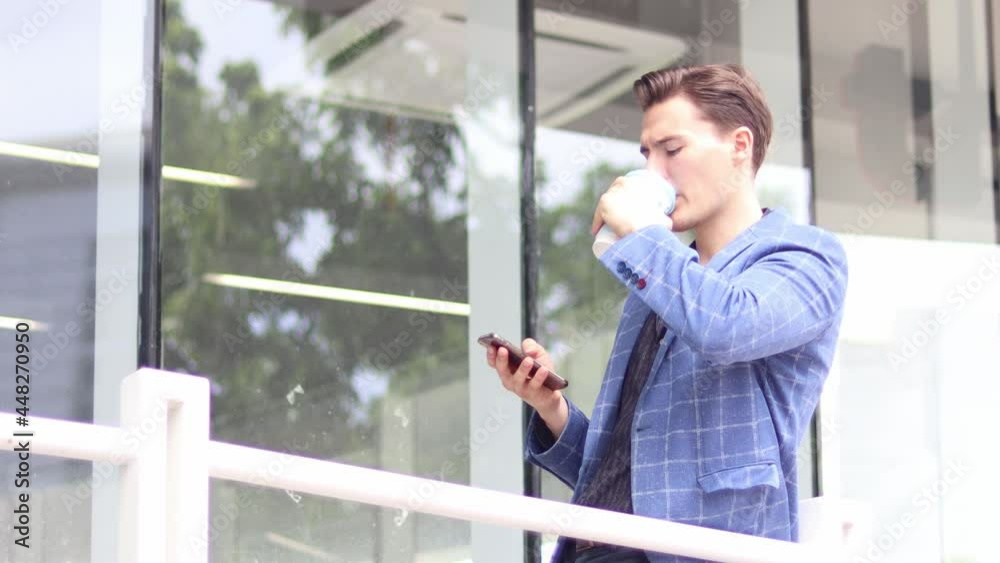 Handsome businessman using a mobile phone. Young man texting Messages, Social Networking. People. Apps. Handsome businessman using a mobile phone. Young man texting Messages, Social Networking. People. Apps.