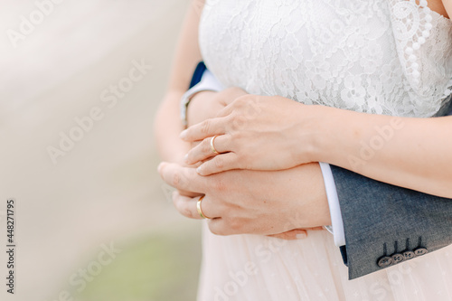 Bride and groom hold hands on the beach of the North Sea 