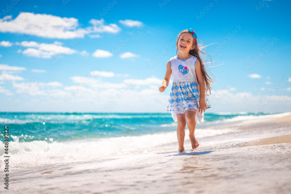 Happy girl running on tropical beach on summer holidays Happy girl running on tropical beach on summer holidays