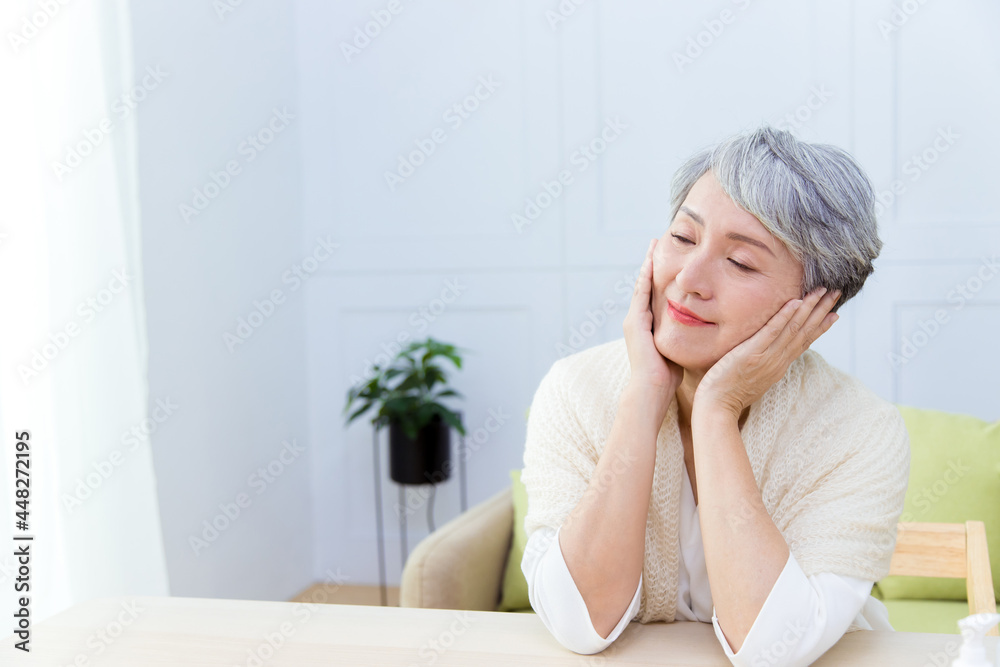 The beauty Senior Asian woman with grey hair enjoys doing skin care. The beauty Senior Asian woman with grey hair enjoys doing skin care.