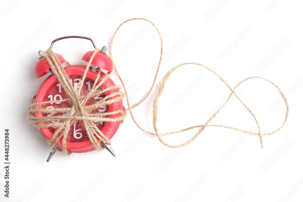 Red alarm clock on a yellow background. Red alarm clock on a yellow background.