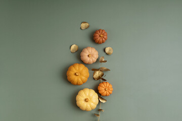 Composition of handmade plaster pumpkins. Autumn seasonal holidays background in natural colors. DIY craft gypsum pumpkins for helloween, thanksgiving, fall decoration