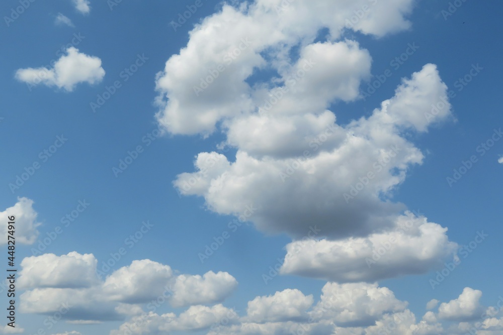 Beautiful fluffy clouds in the blue sky, natural background Beautiful fluffy clouds in the blue sky, natural background