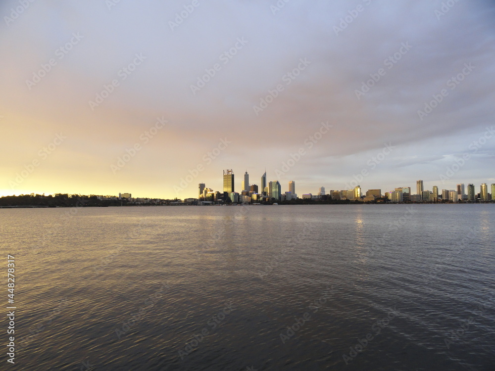 Skyline of a big city, its river and its skyscrapers during the sunset. Perth and the Swan River, Australia. View from Victoria Park.