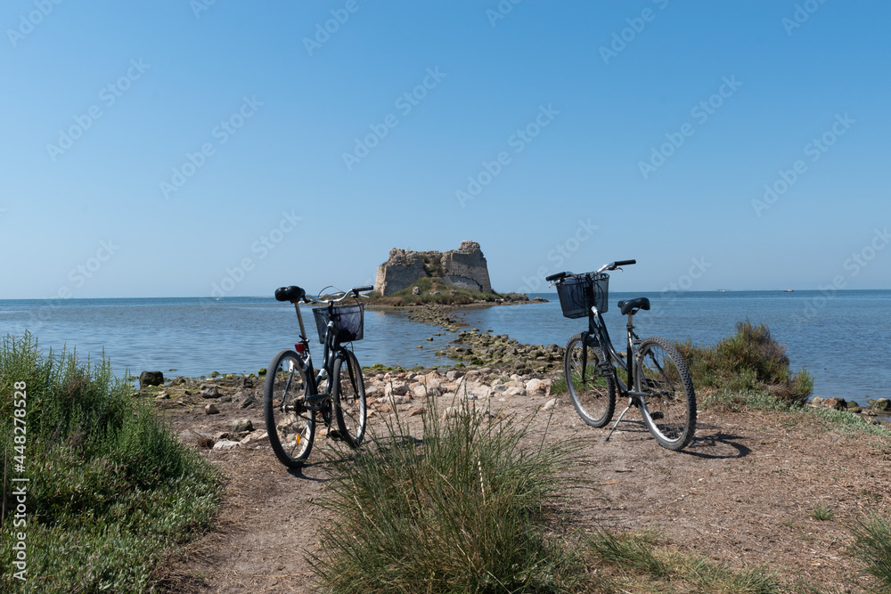 bicycles next to a ruins in the sea