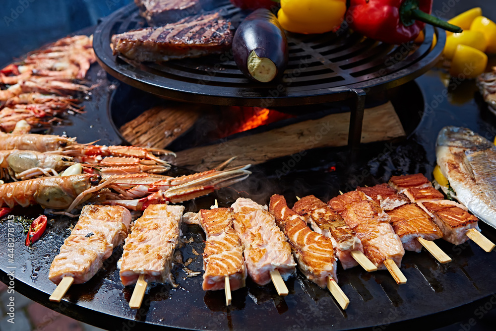 Grilled fresh seafood: prawns, fish, octopus, oysters food background Barbecue Cooking BBQ