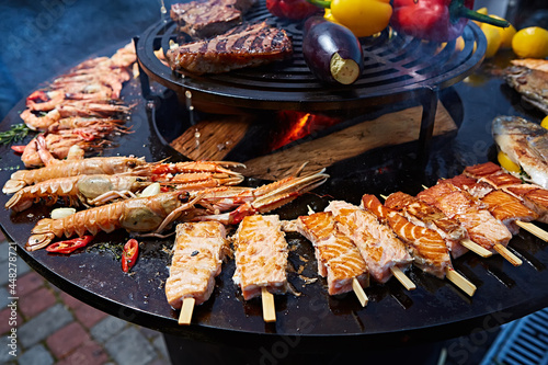 Grilled fresh seafood: prawns, fish, octopus, oysters food background Barbecue Cooking BBQ