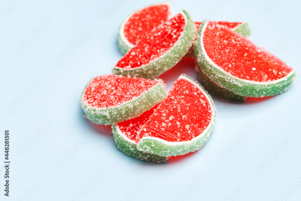 Jelly candies. Close-up of jelly candies on a blue background. Watermelon marmalade. Selective soft focus. Jelly candies. Close-up of jelly candies on a blue background. Watermelon marmalade. Selective soft focus.