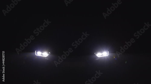 Car headlight blinking in Dark. Sports car Headlight. Switching of car LED headlights in night photo