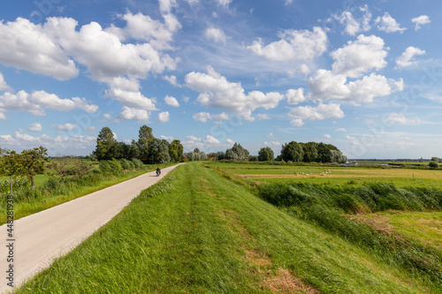 Obraz na plátně Clouds, a blue sky and a lot of wind above the rural polder landscape in the Netherlands