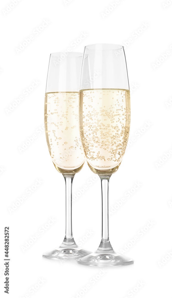Glasses of sparkling wine on white background