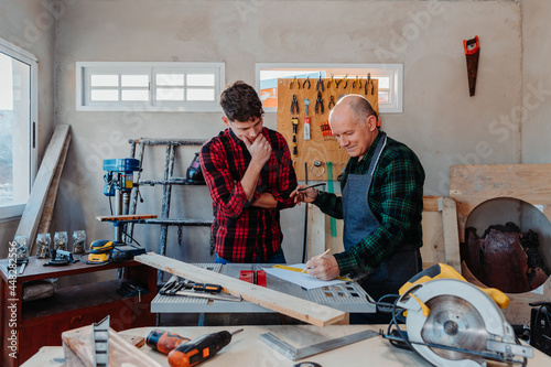 father and son in their carpentry workshop