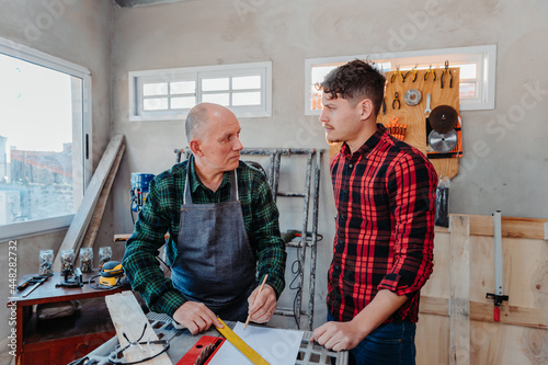 father and son in their carpentry workshop