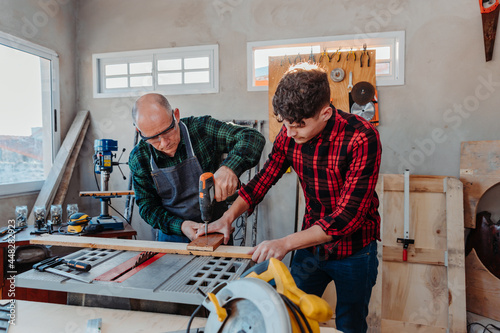 father and son in their carpentry workshop