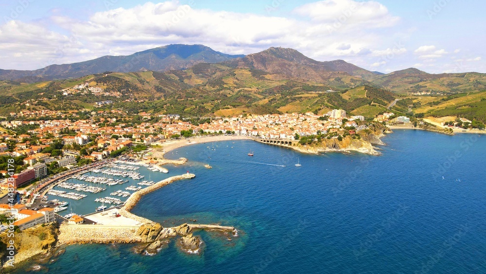 Aerial view from the sea of the city of Banyuls-sur-Mer and Massif des Albères on the Côte Vermeille in Pyrénées-Orientales, France