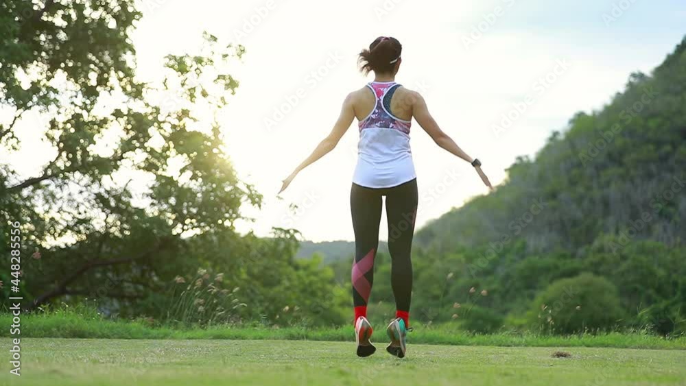 woman in sports outfit doing jump slap stretching warm up before workout woman in sports outfit doing jump slap stretching warm up before workout
