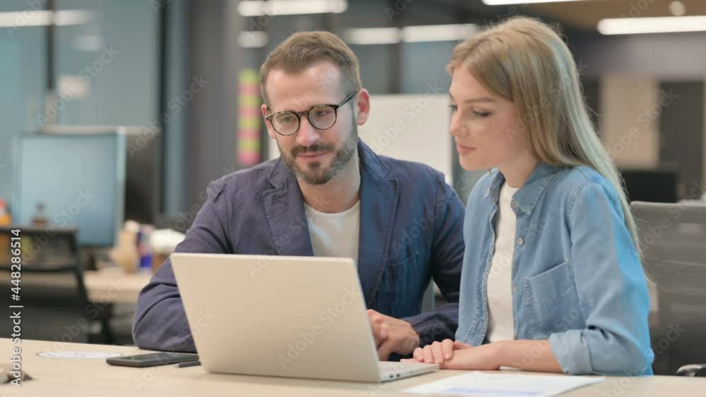Middle Aged Businessman and Businesswoman Talking on Video Call on Laptop Middle Aged Businessman and Businesswoman Talking on Video Call on Laptop