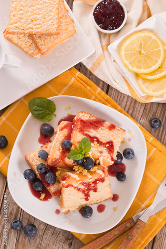 Lemon pund cake with blueberries and strawberry syrup.