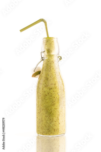 Bottle of delicious green kiwi or avocado or spinach smoothie with a straw isolated on white background. Healthy, detox and diet food concept