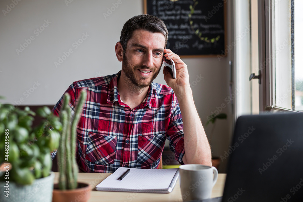 Man on the phone working from home Man on the phone working from home