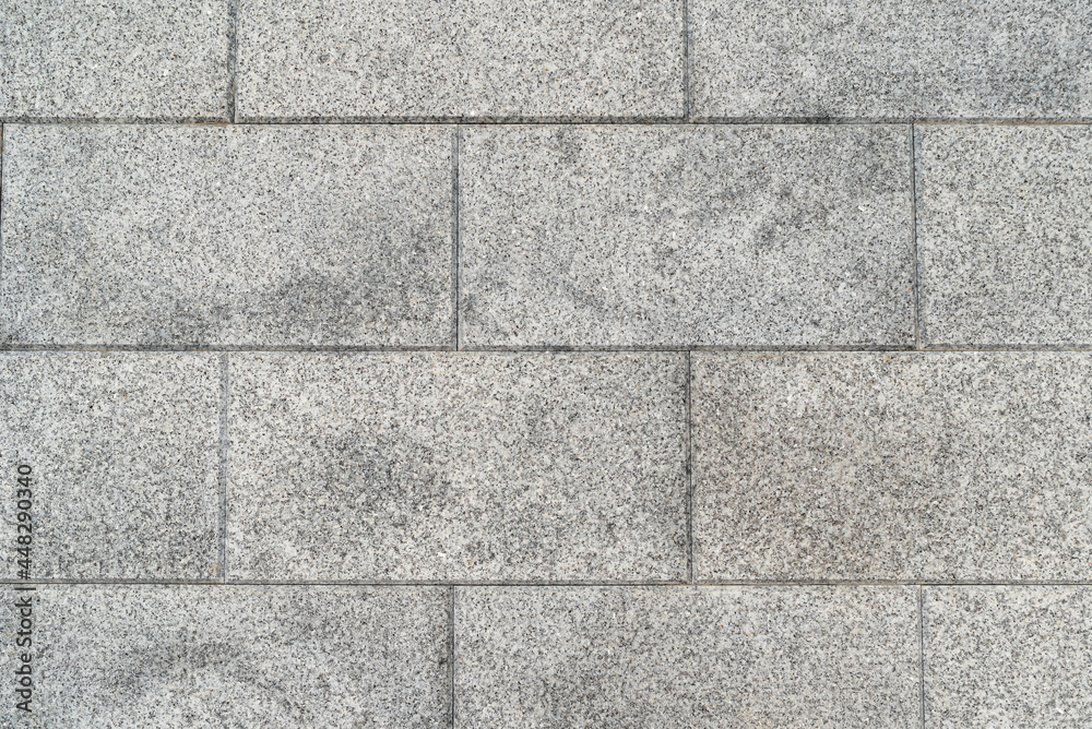 Naklejka premium The texture of natural gray granite tiles, background.
