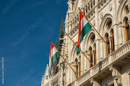 Hungarian flags on the Hungarian Parliament Building or Parliament of Budapest, a landmark and popular tourist destination in Budapest, Hungary
