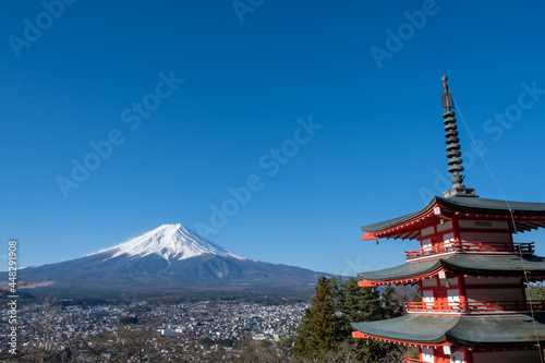 The iconic view of Mount Fuji with the red Chureito pagoda and Fujiyoshida city from Arakurayama sengen park in Yamanashi Prefecture  Japan.